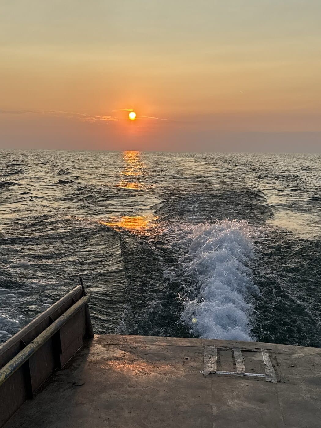 The wake off the stern of our boat at sunset on Lake Erie