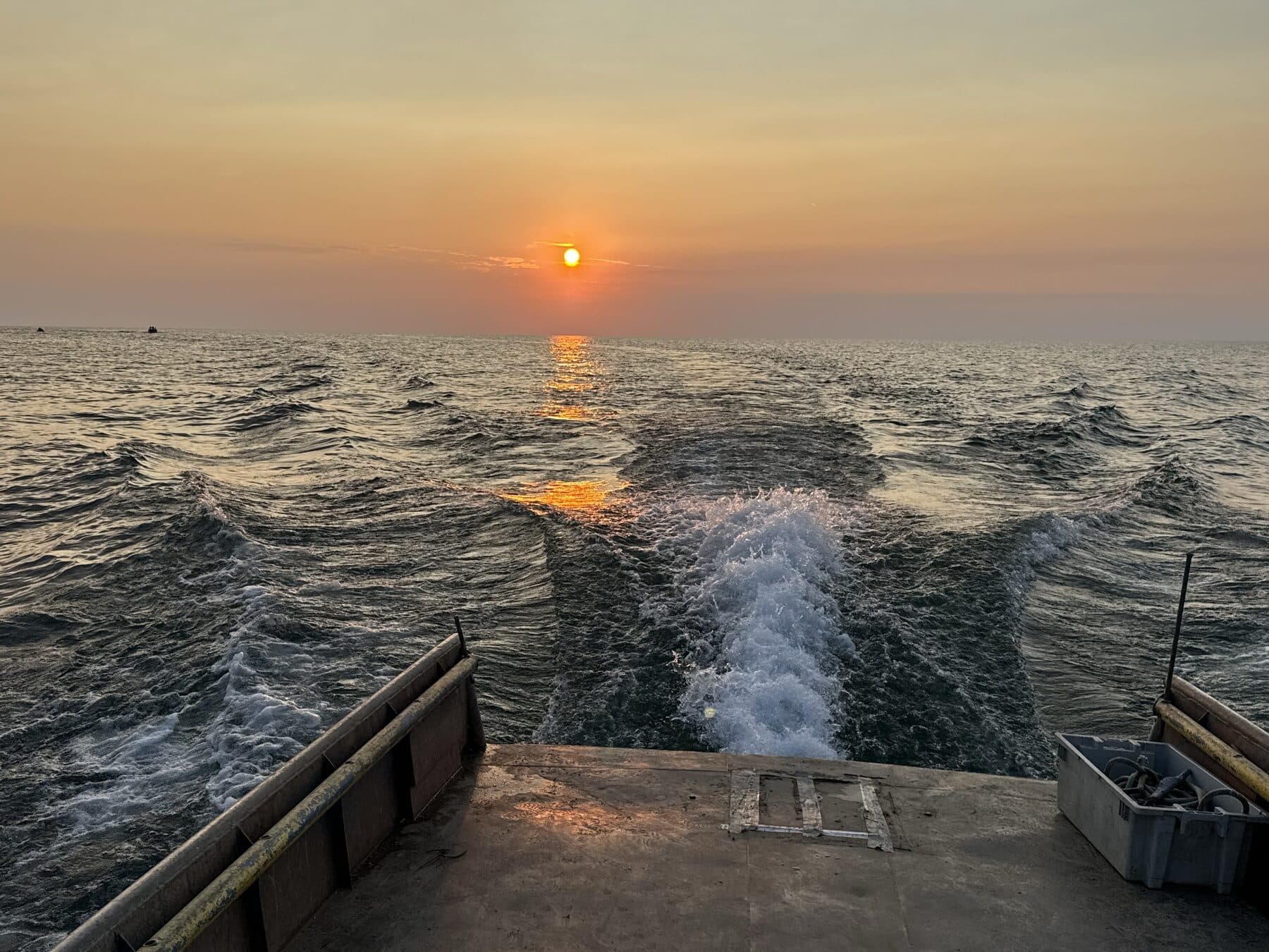 The wake off the stern of our boat at sunset on Lake Erie